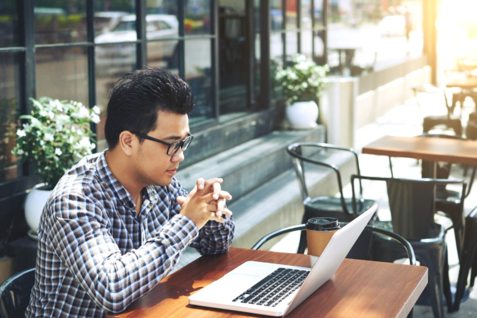 Students working on database administration projects in modern learning environment